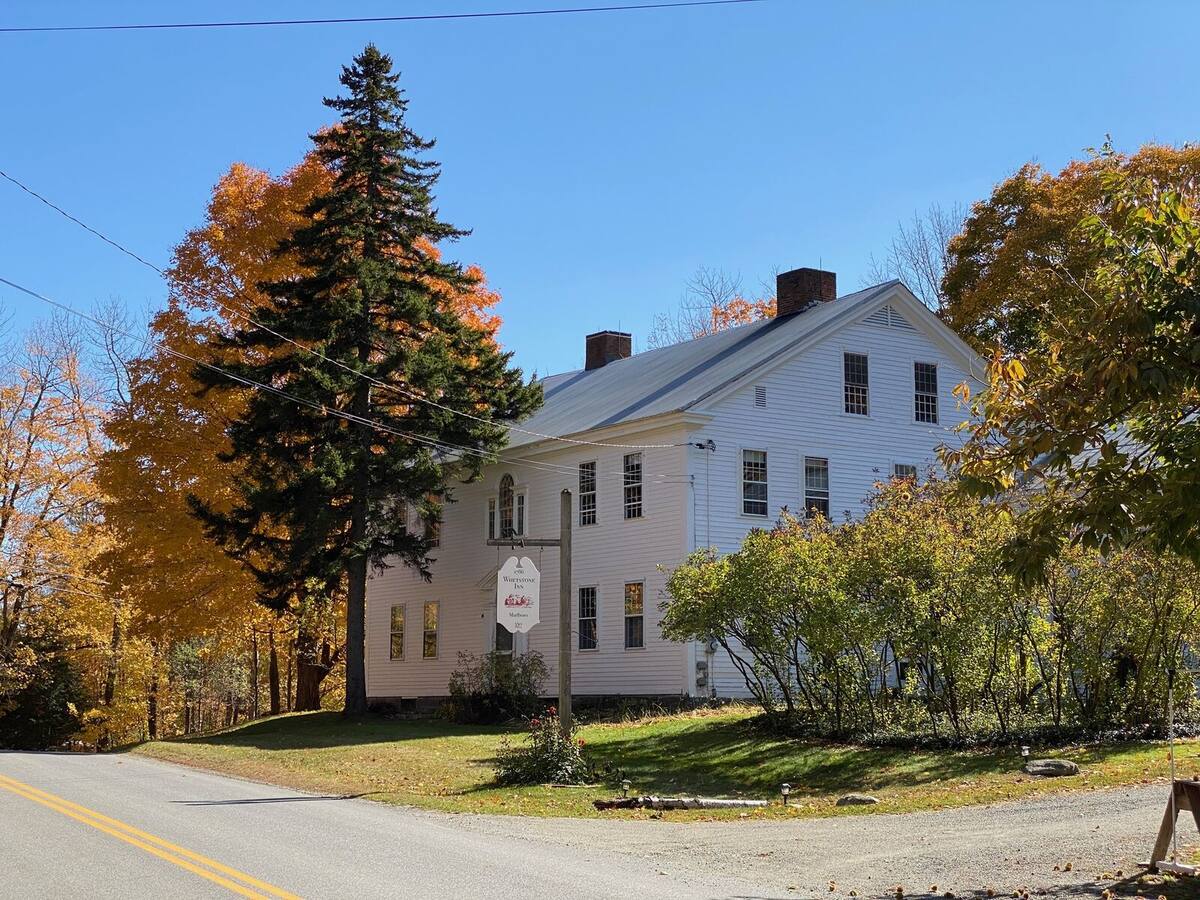 The inn from South Road — white clapboard behind the maples